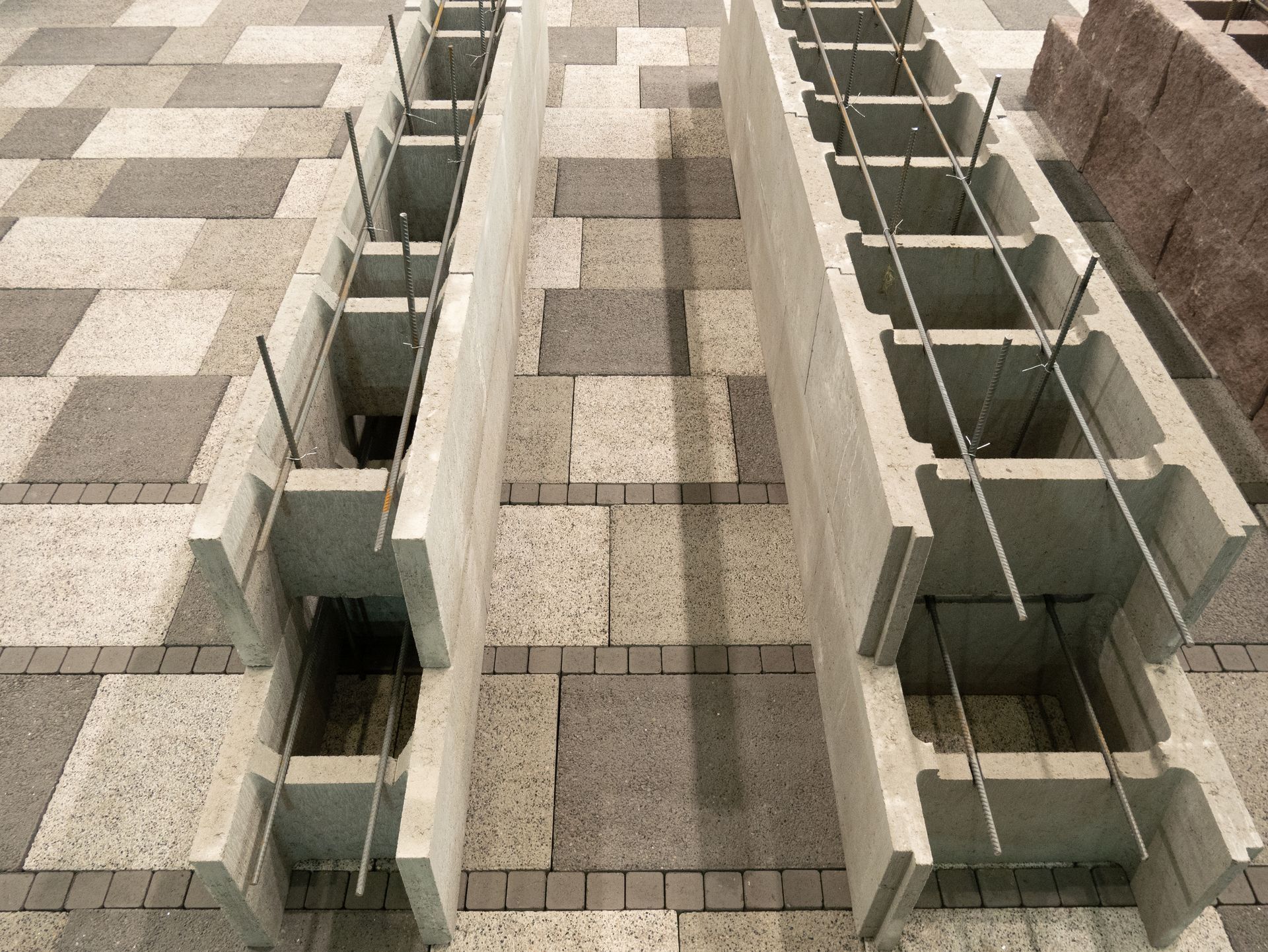 Concrete blocks with rebar reinforcement; construction in progress.