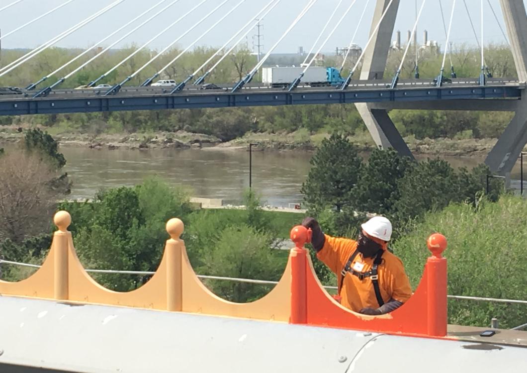 Dayco team applying bright orange paint to the top of the casino