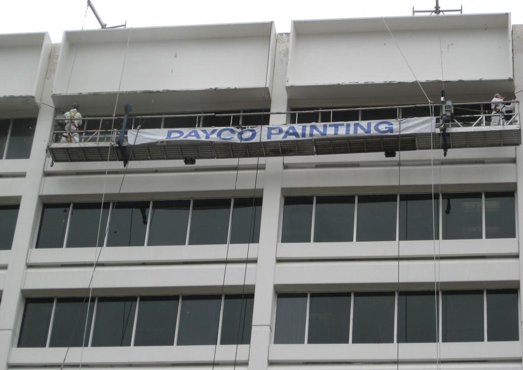 Large freshly painted office building with a 'Dayco Painting' banner across the top.