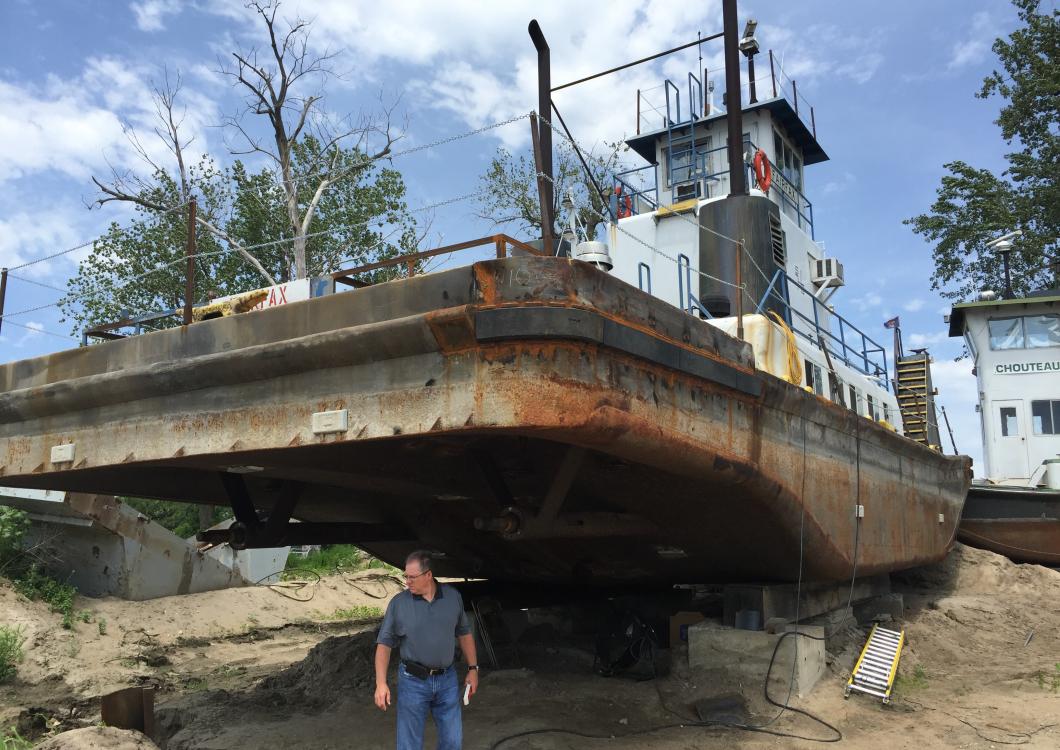Dayco working to restore paint on boat.