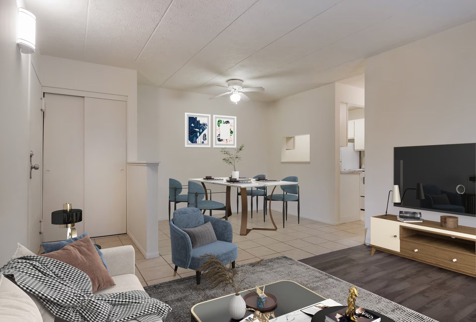 Living room with dining area. White walls, wood floor, blue accents, TV, table, chairs.