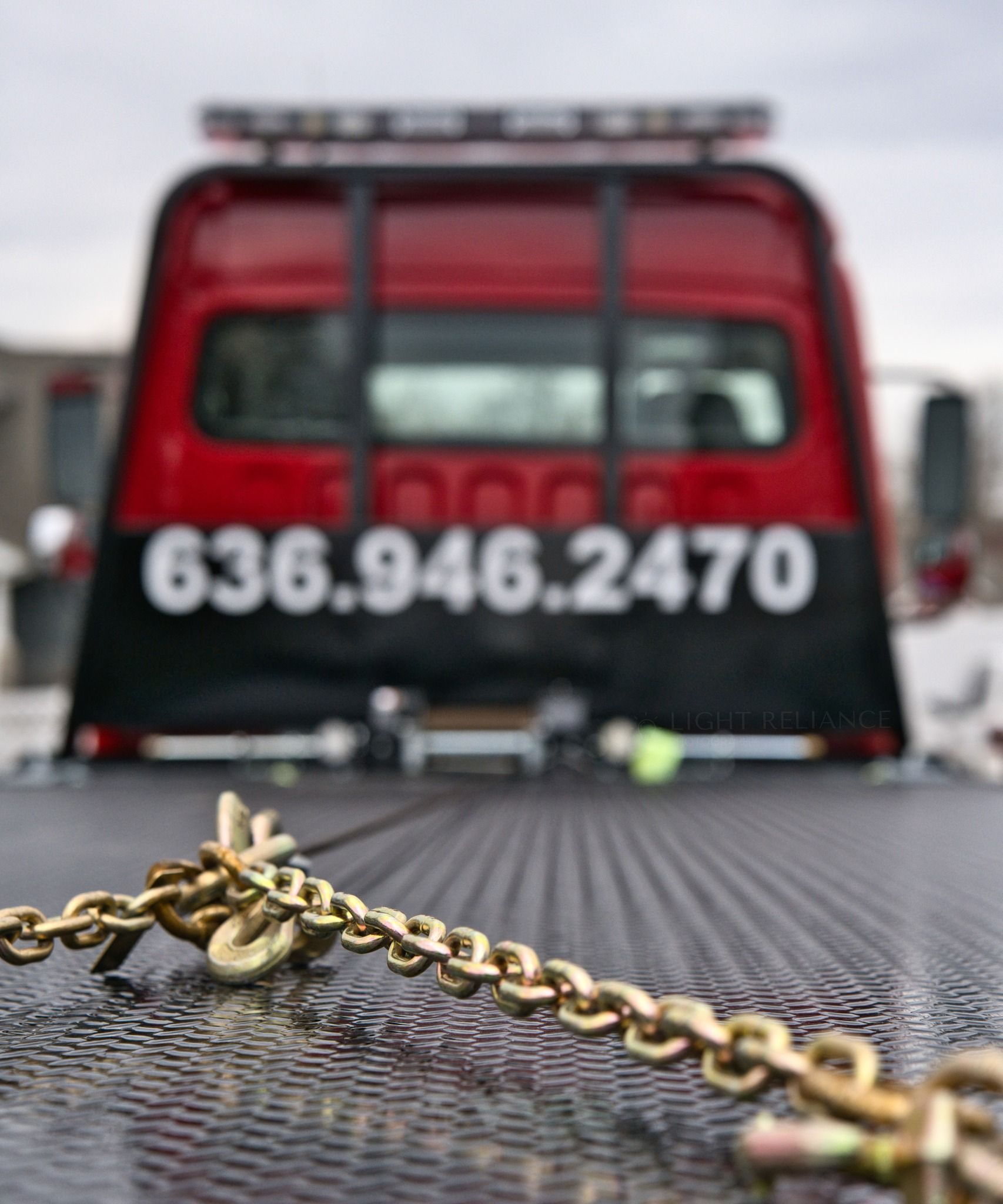 Tow truck bed with a chain.