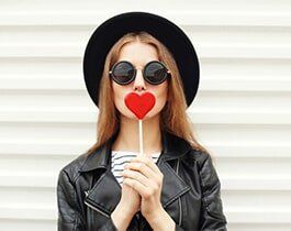 Adjustments — Woman Holding a Heart-shaped Lollipop in San Rafael, CA