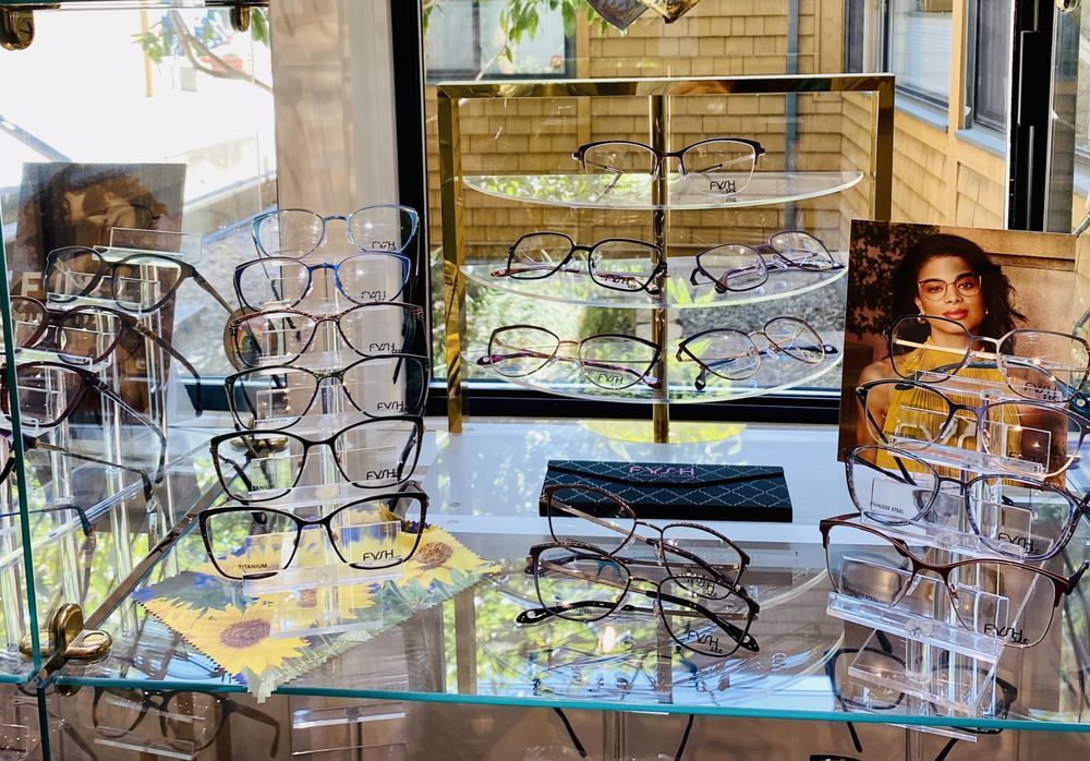 A display case filled with glasses and a picture of a woman  — Eye Care in San Rafael, CA