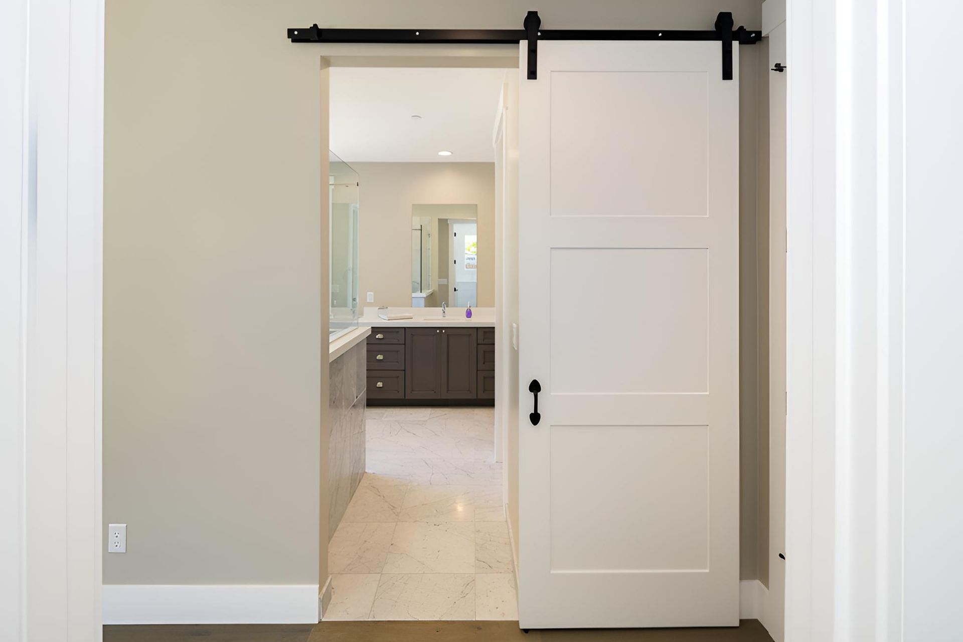 White Sliding Barn Door is Open to a Bathroom — Ezi Slide - Glass, Sliding, Track & Security Doors Repair in Ashmore, QLD