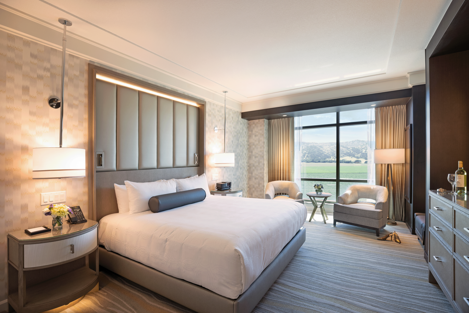 A person is opening a door in a hotel room.