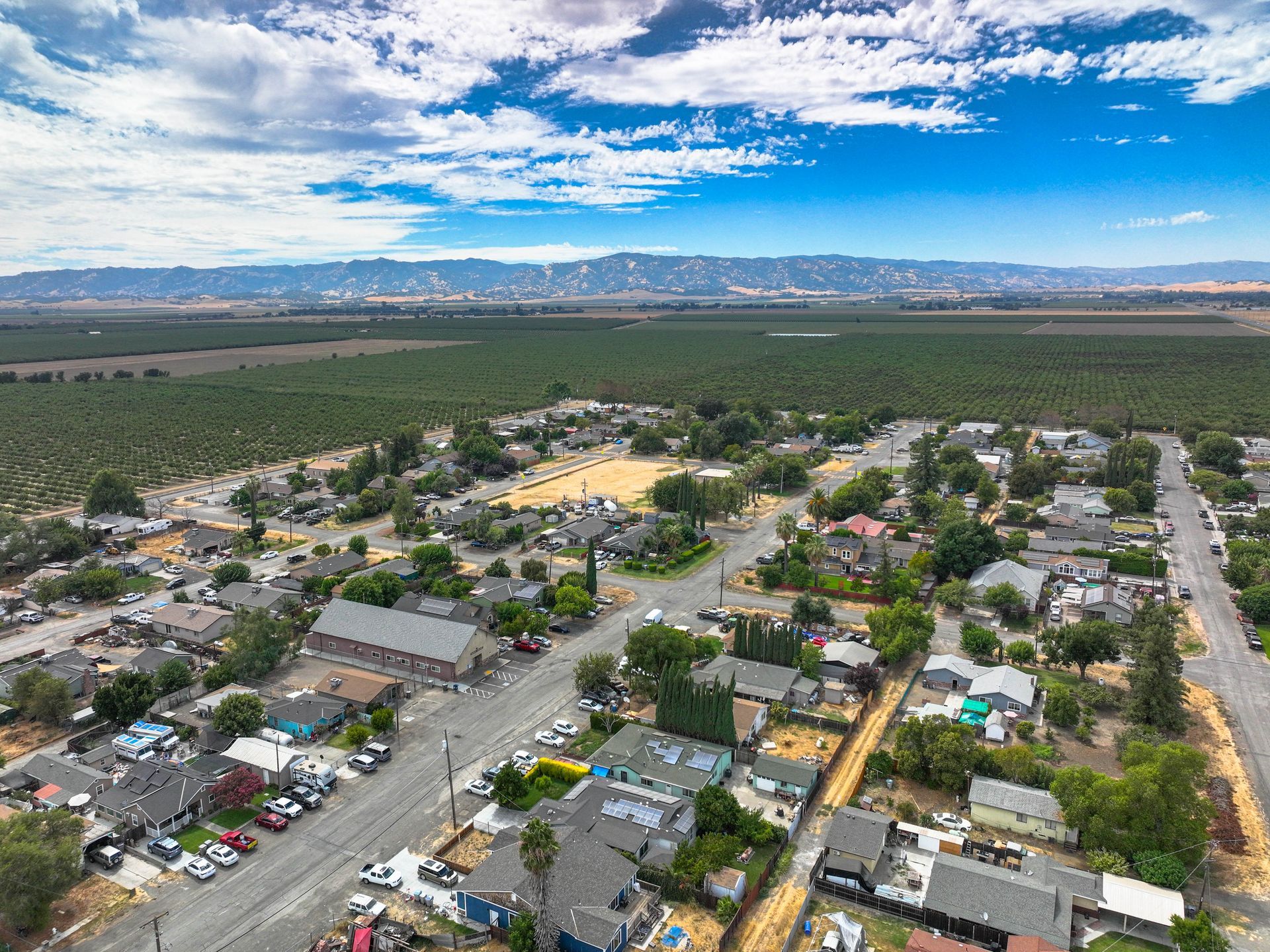 An aerial view of a residential area with mountains in the background.