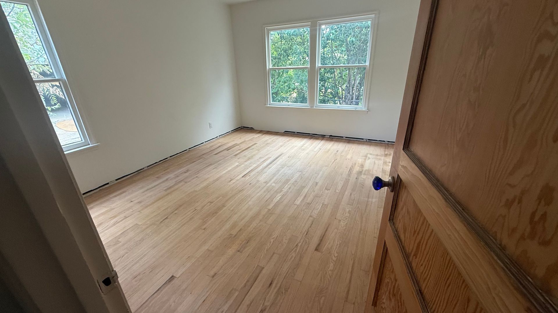 A man and a woman are installing a wooden floor.