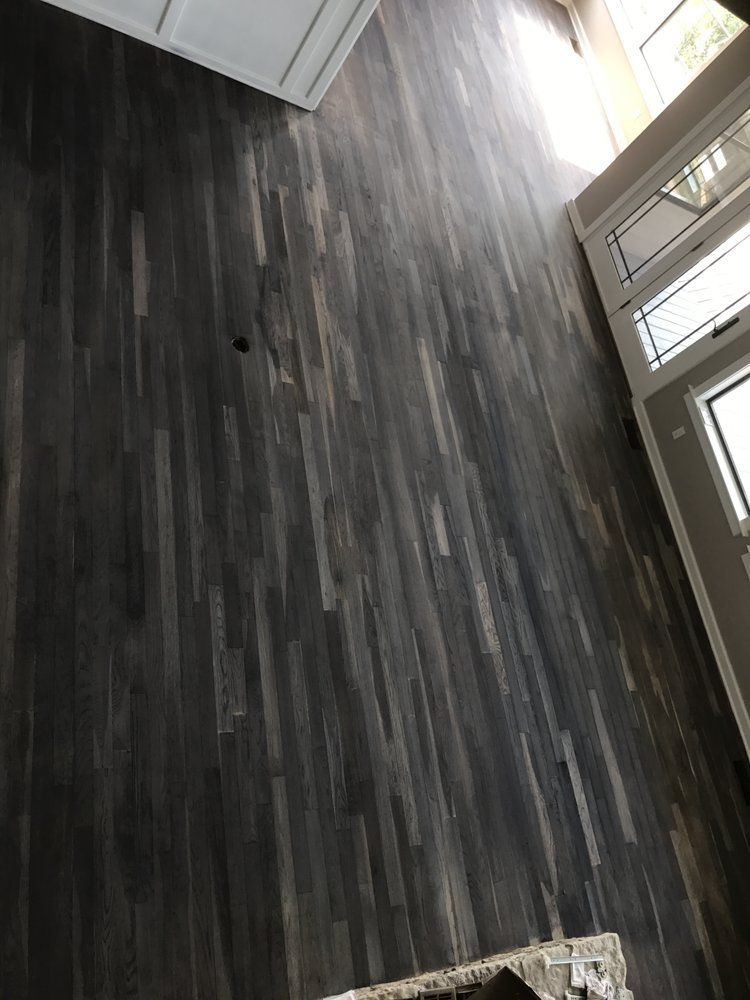 A living room with a wooden floor and a couch.