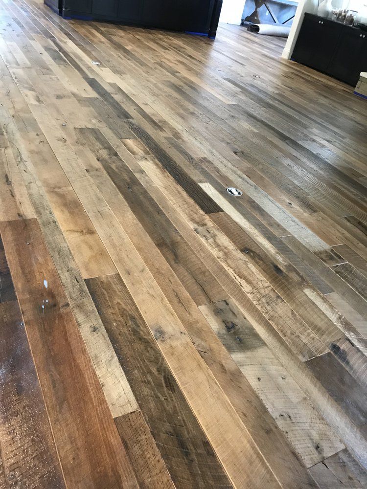 A close up of a wooden floor in a living room.