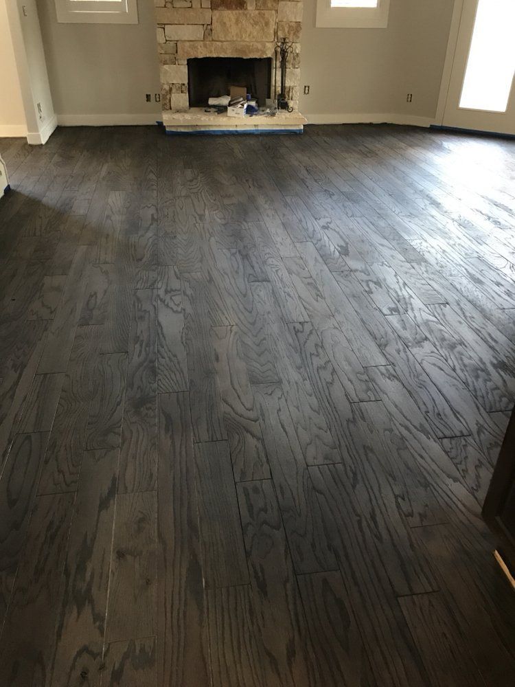 A living room with hardwood floors and a fireplace.