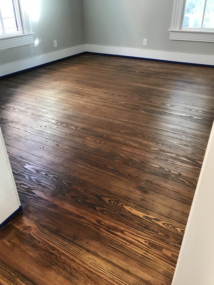 A room with a wooden floor and a window.