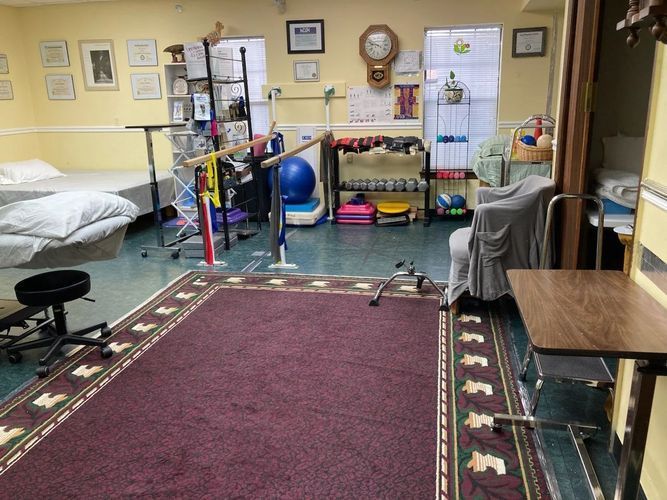 A room with a purple rug and a wooden table