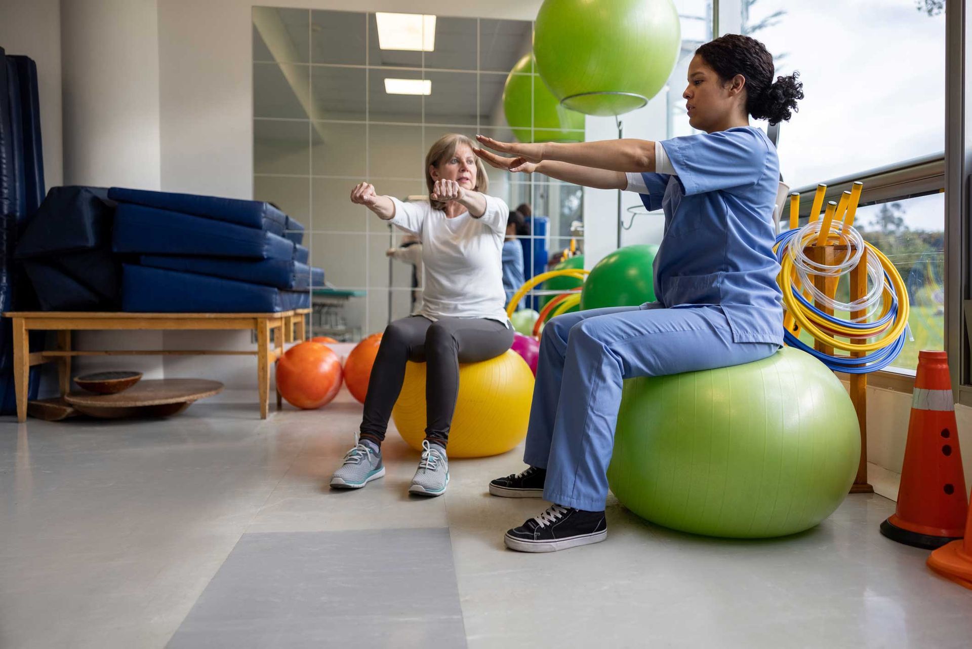 Physical Therapist Showing a Woman an Exercise — Modesto, CA — Athletic & Industrial Rehabilitation