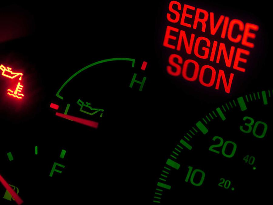 A close up of a service engine soon sign on a dashboard