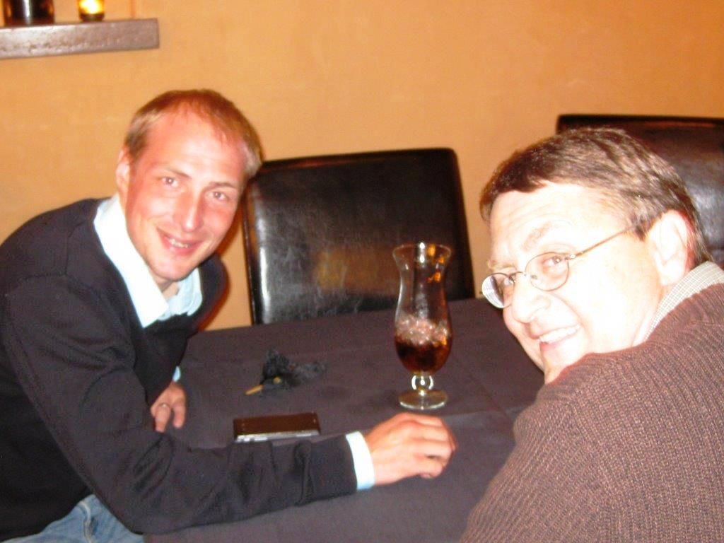 Two men seated at a table.