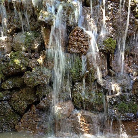Waterfall cascading over mossy rocks.