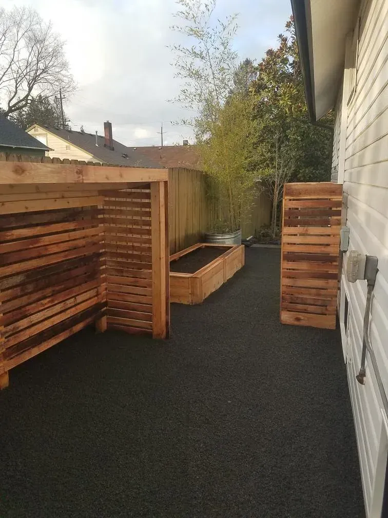 Wooden structures on black ground in a backyard. 