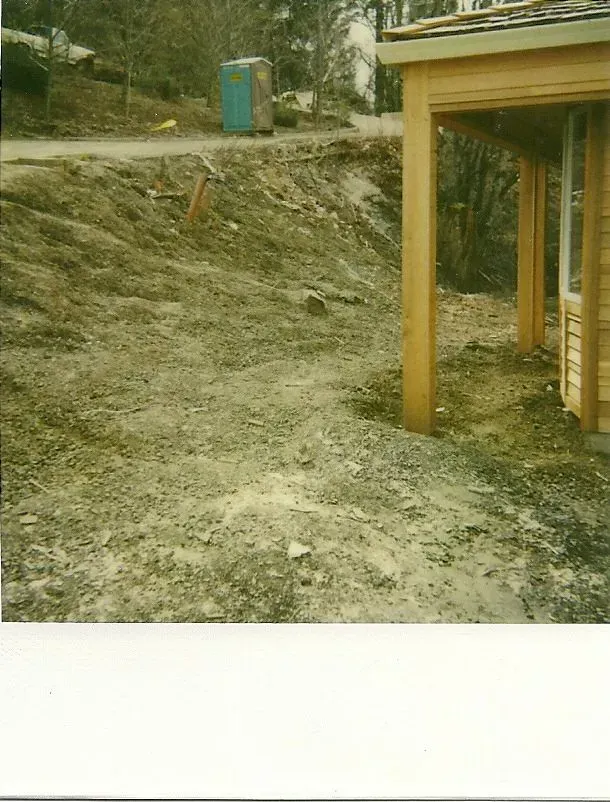 A construction site with a partially built wooden structure on the right.