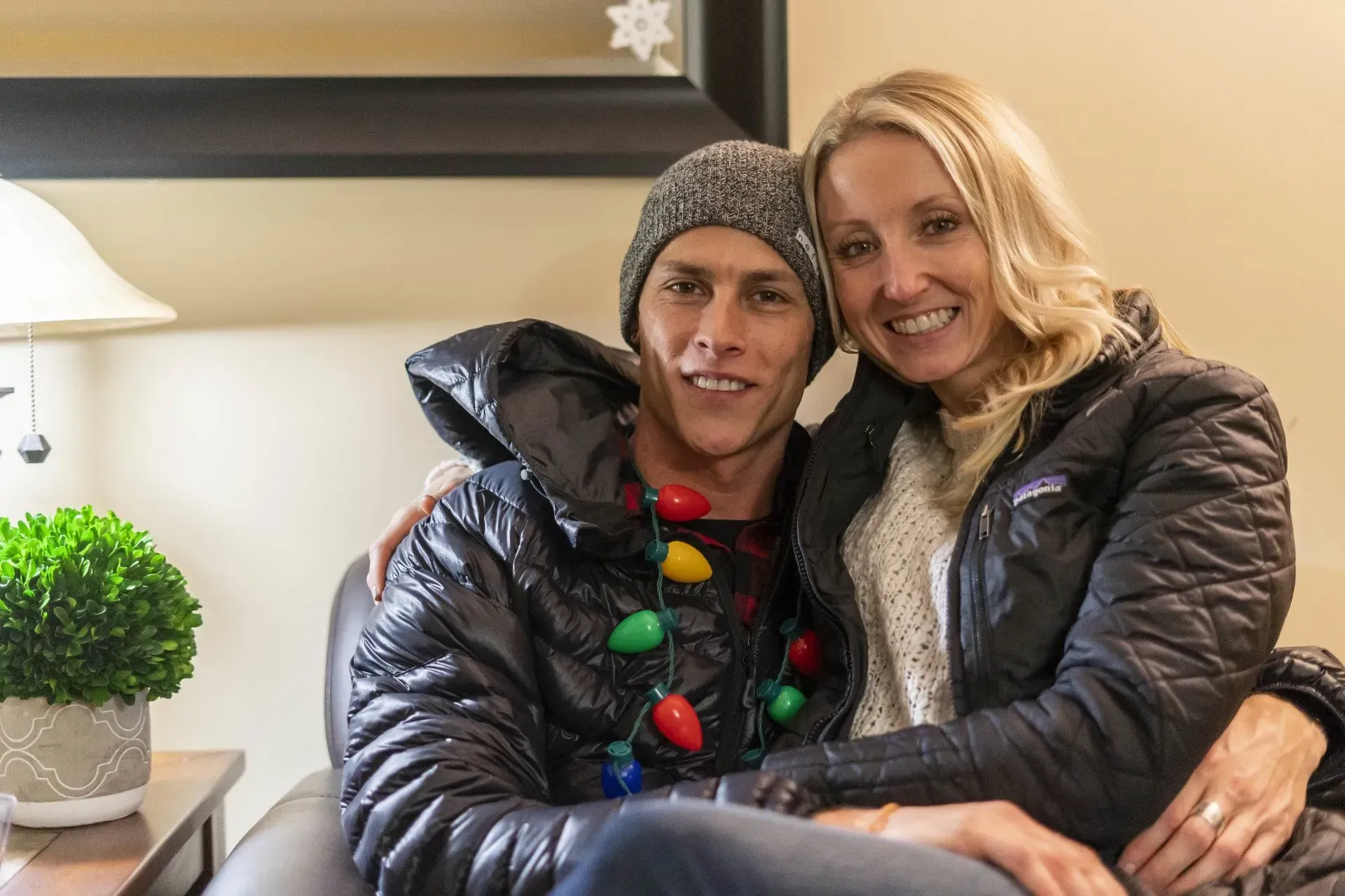 A smiling couple sits close together.