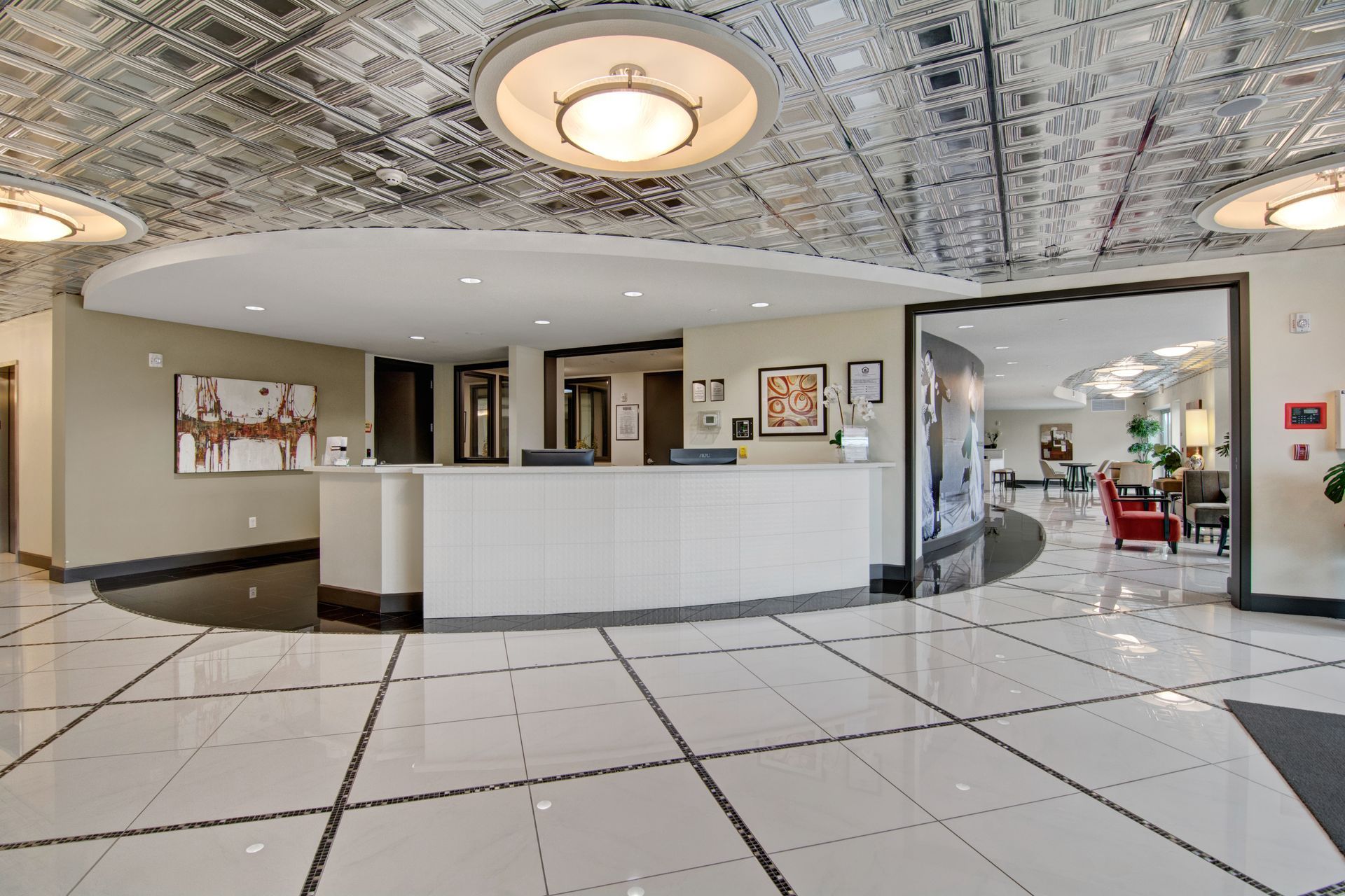 A lobby with a white counter and a ceiling.