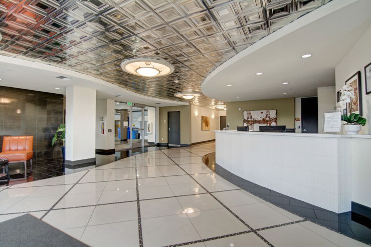 A large lobby with a curved ceiling and a white counter.