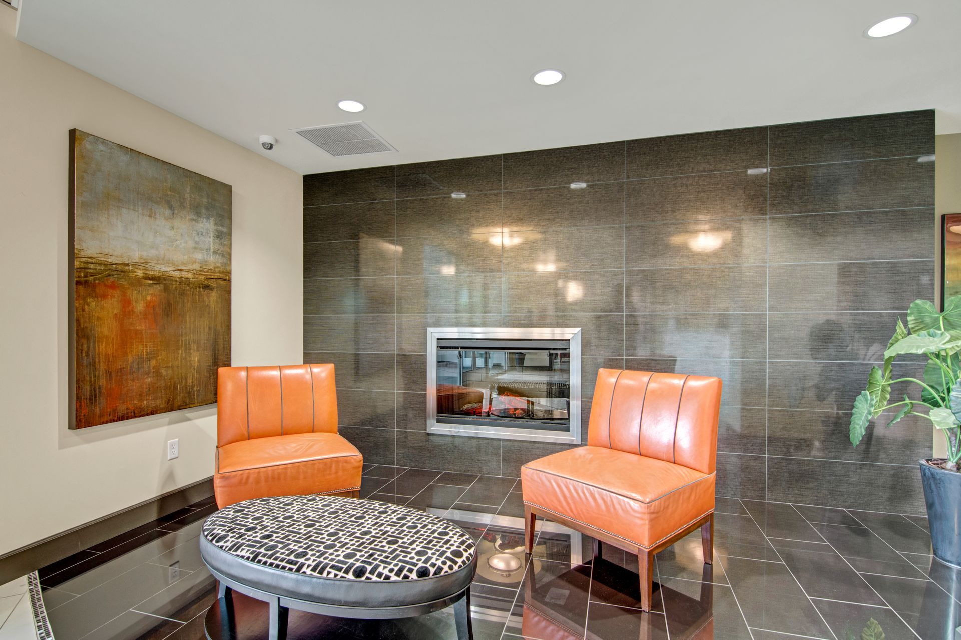 A room with two chairs and a fireplace.