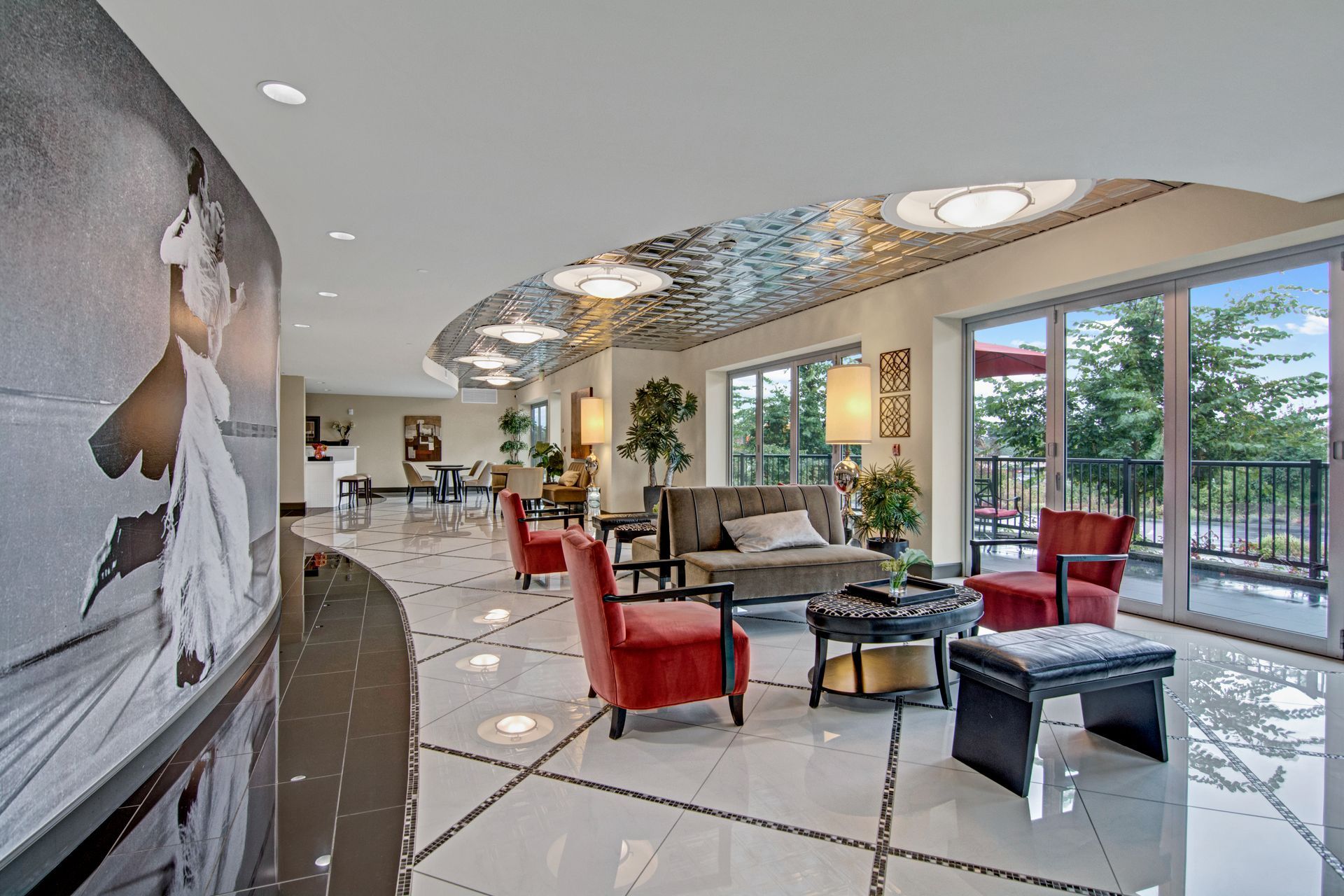 A room with a lot of furniture and a painting on the wall.