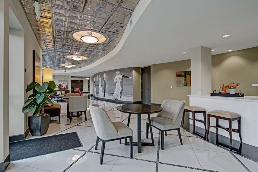 A lobby with a table and chairs.