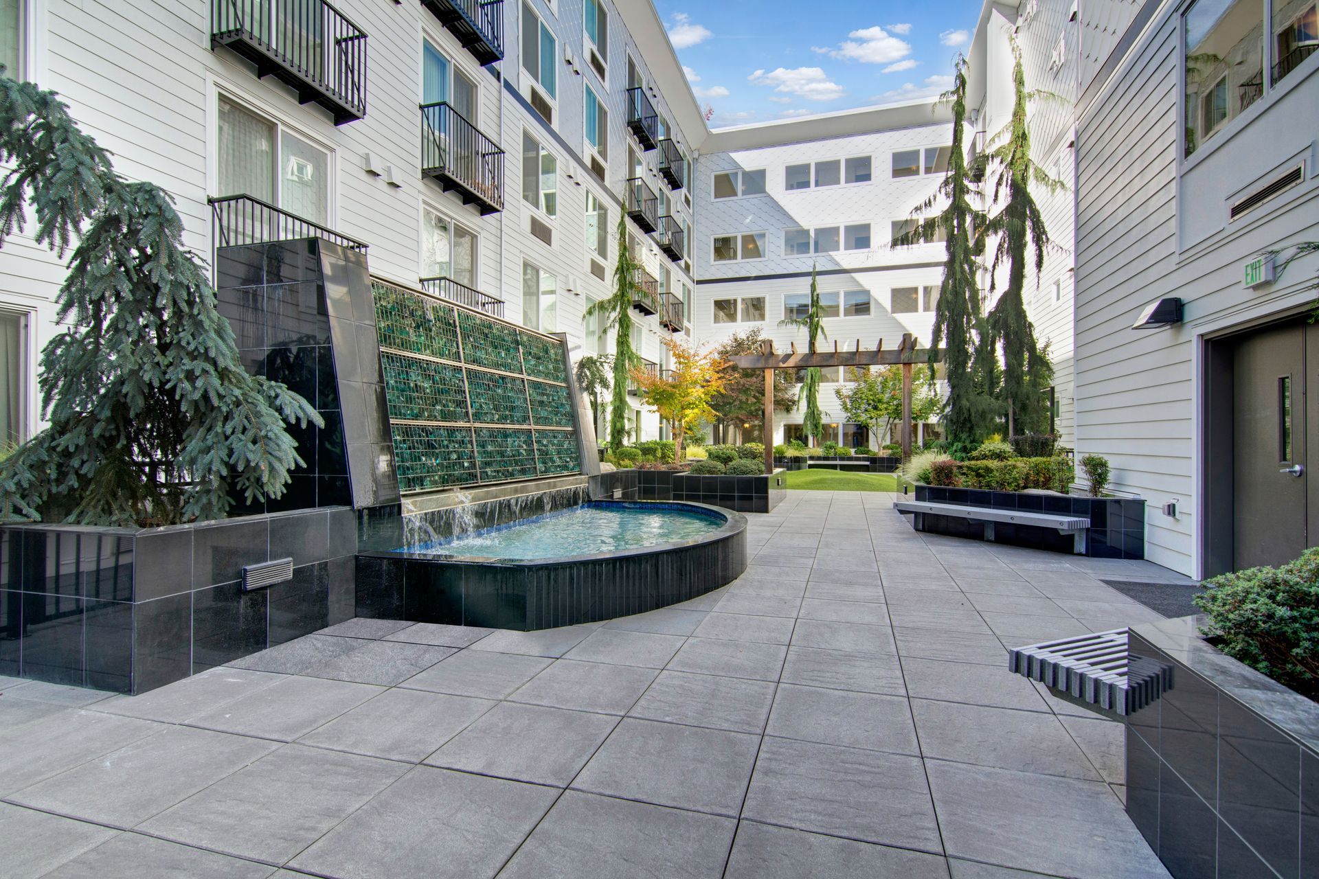 There is a fountain in the middle of the courtyard of a building.