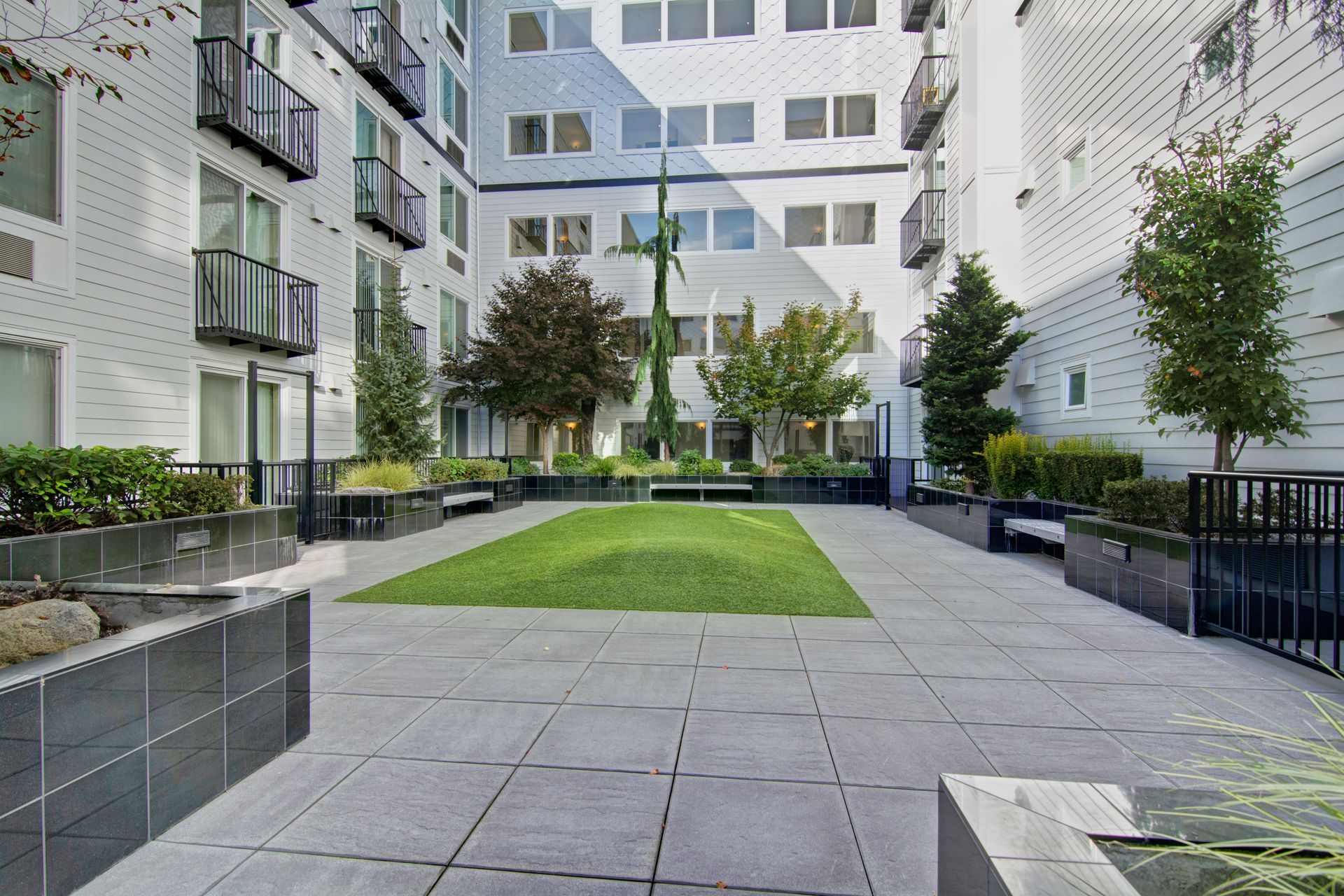 A large building with a lawn in the middle of it.