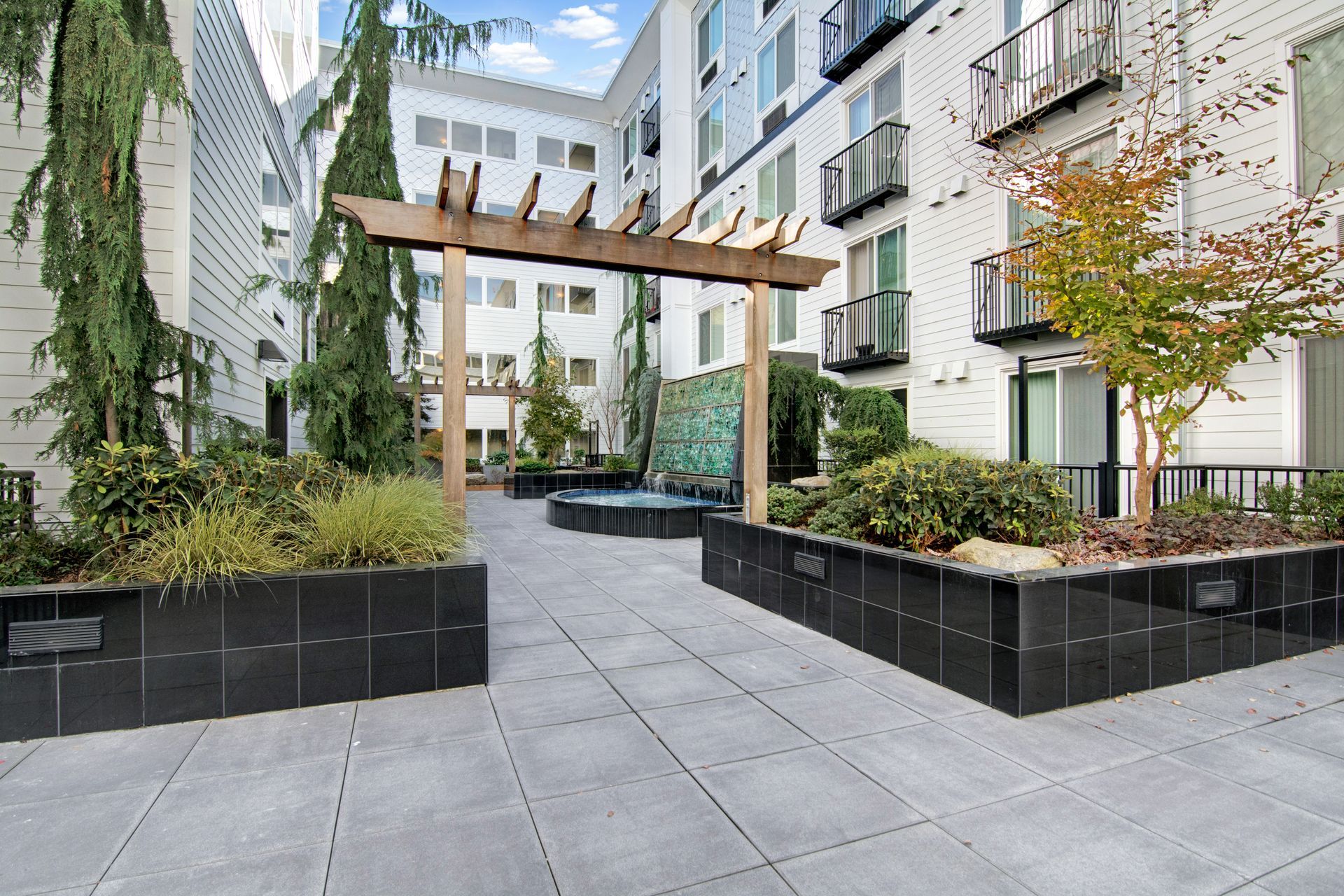 A courtyard with a pergola in the middle of a building.