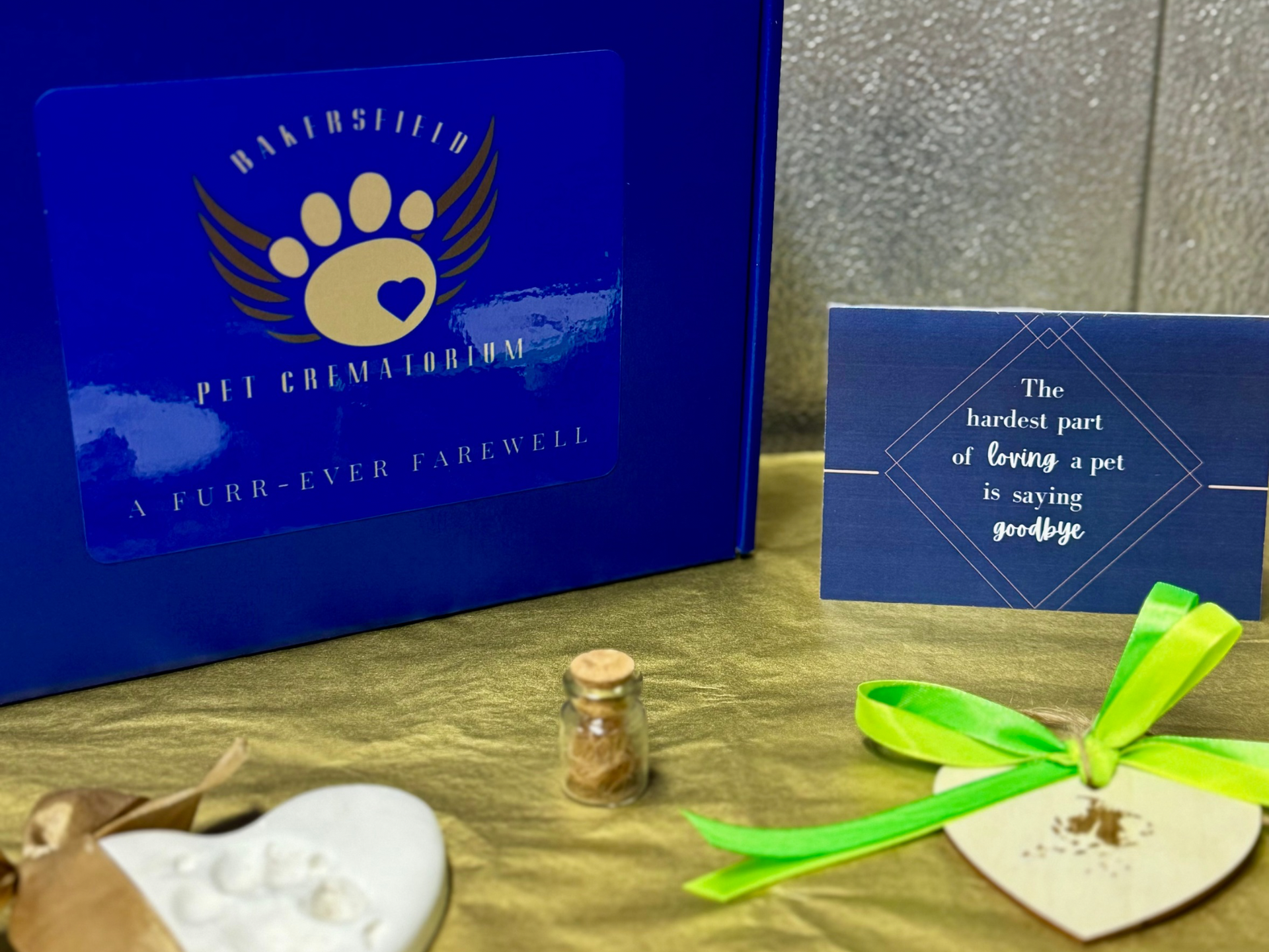 A blue box with a paw print on it is sitting on a table. Keepsake package