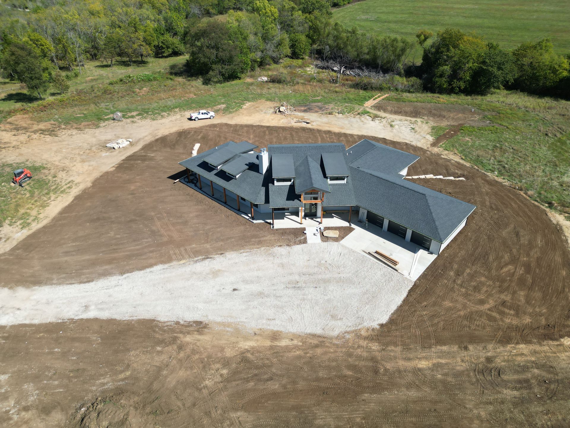 An aerial view of a house under construction in a field.
