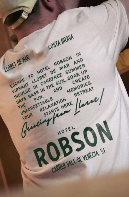 A man is wearing a robson hotel t-shirt