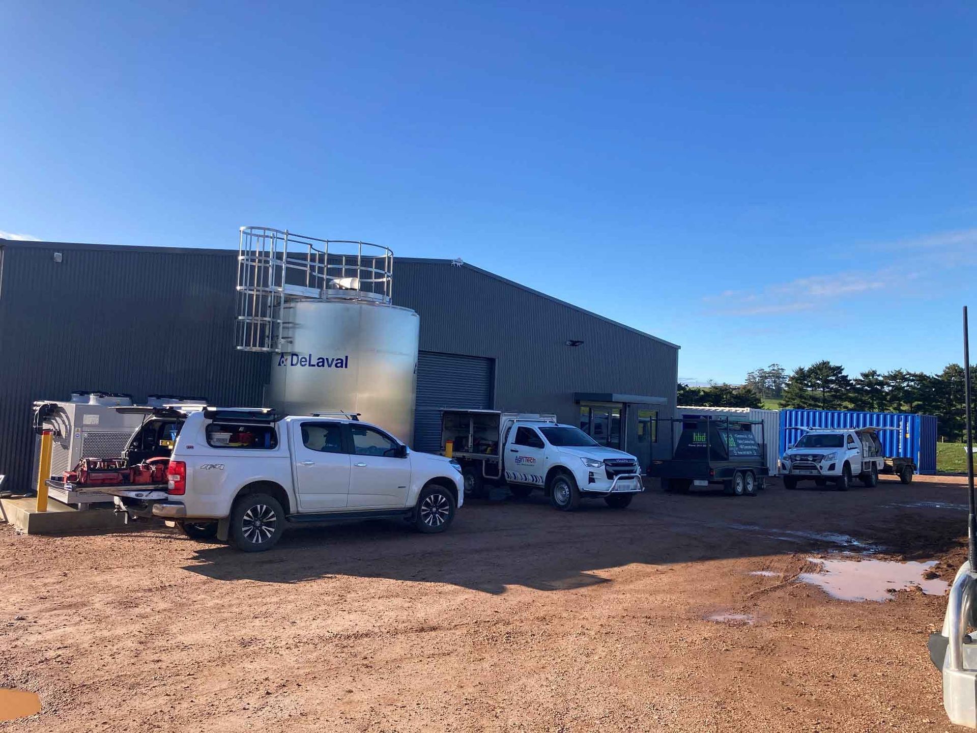 A row of trucks are parked in front of a building.