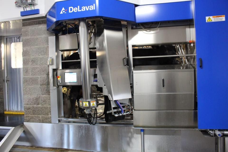 A DeLaval machine is sitting in front of a brick wall
