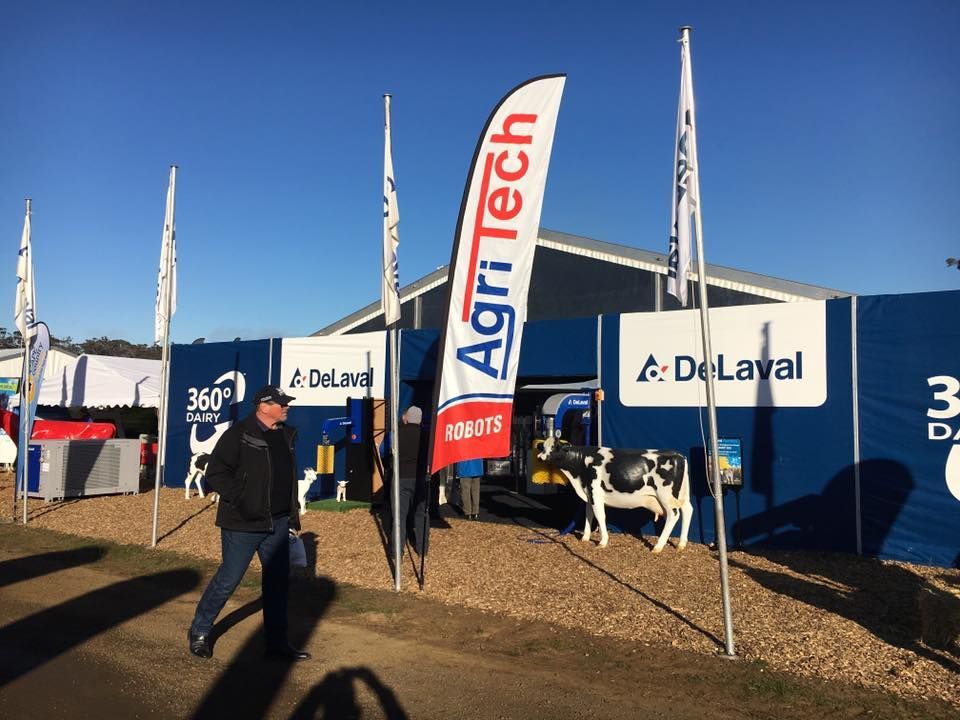 A man walking in front of a sign that says AgriTech