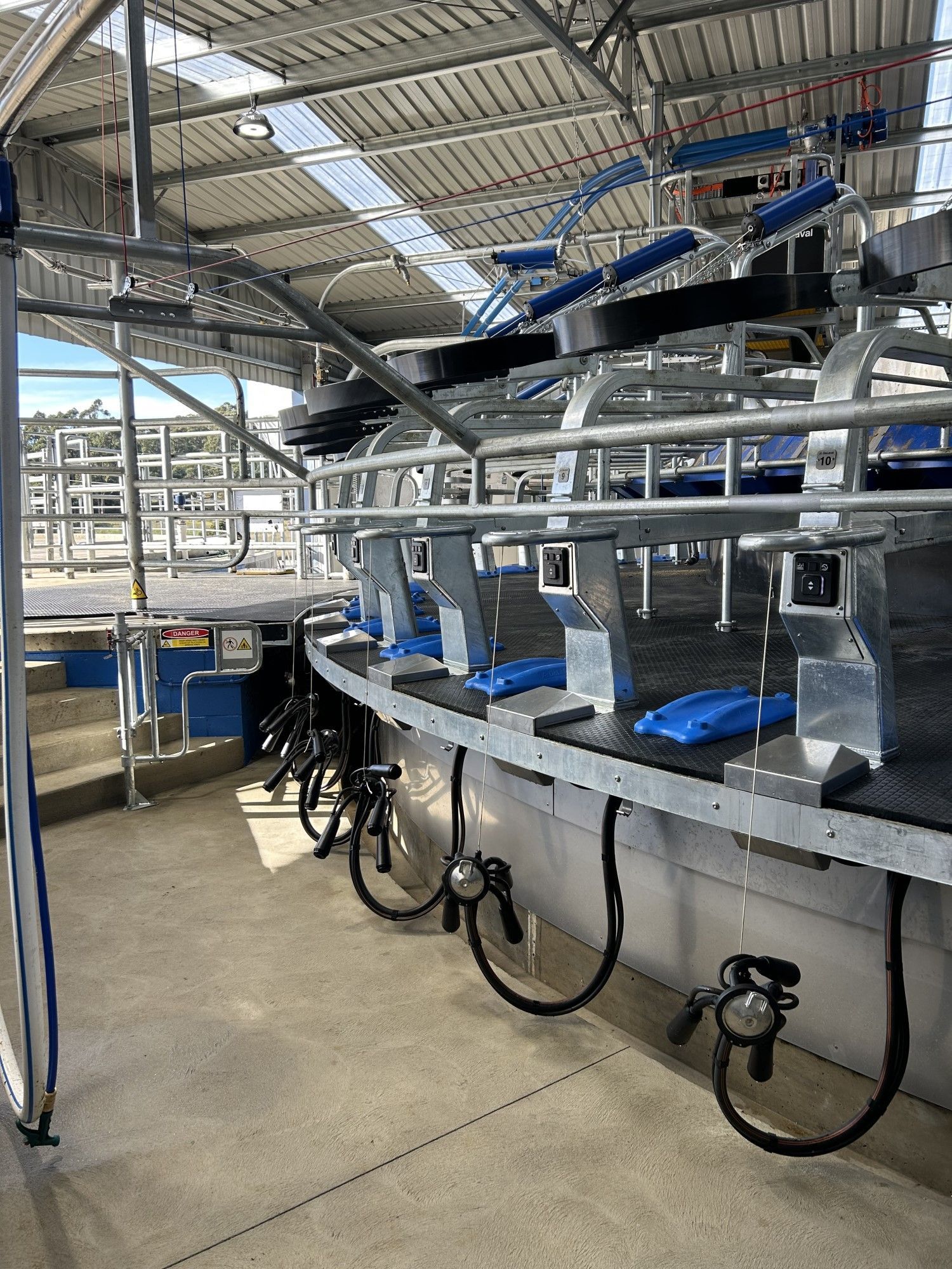 A room with a lot of milking machines in it.