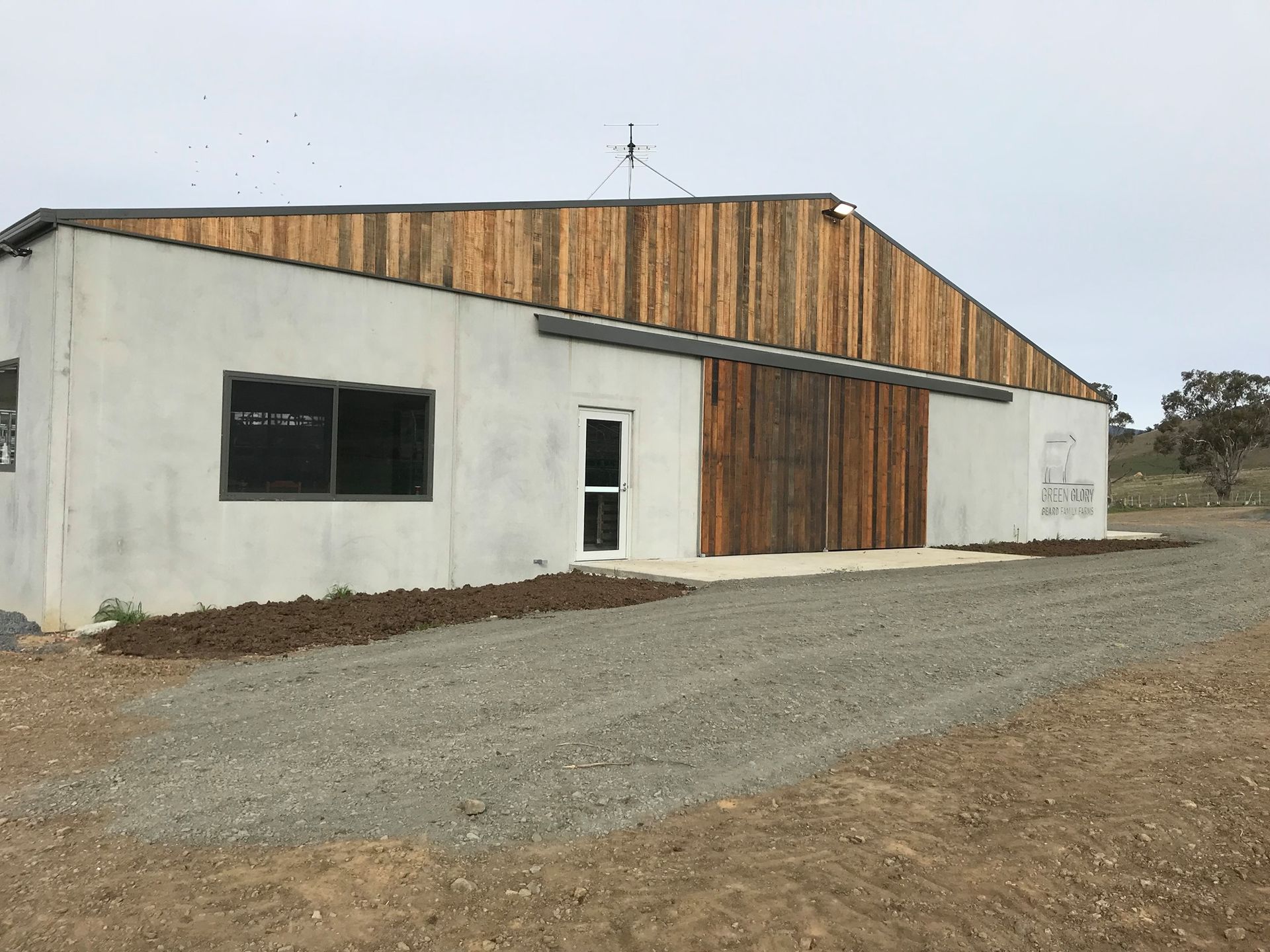 A white building with a wooden roof and sliding doors
