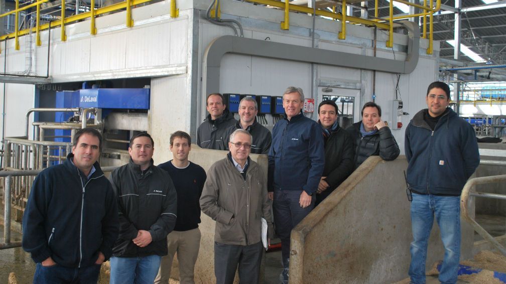 A group of men are posing for a picture in a barn