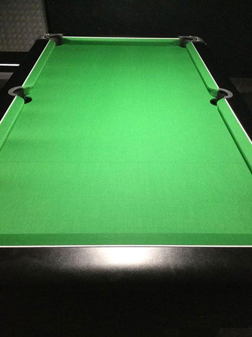 Pool table recovered with green cloth