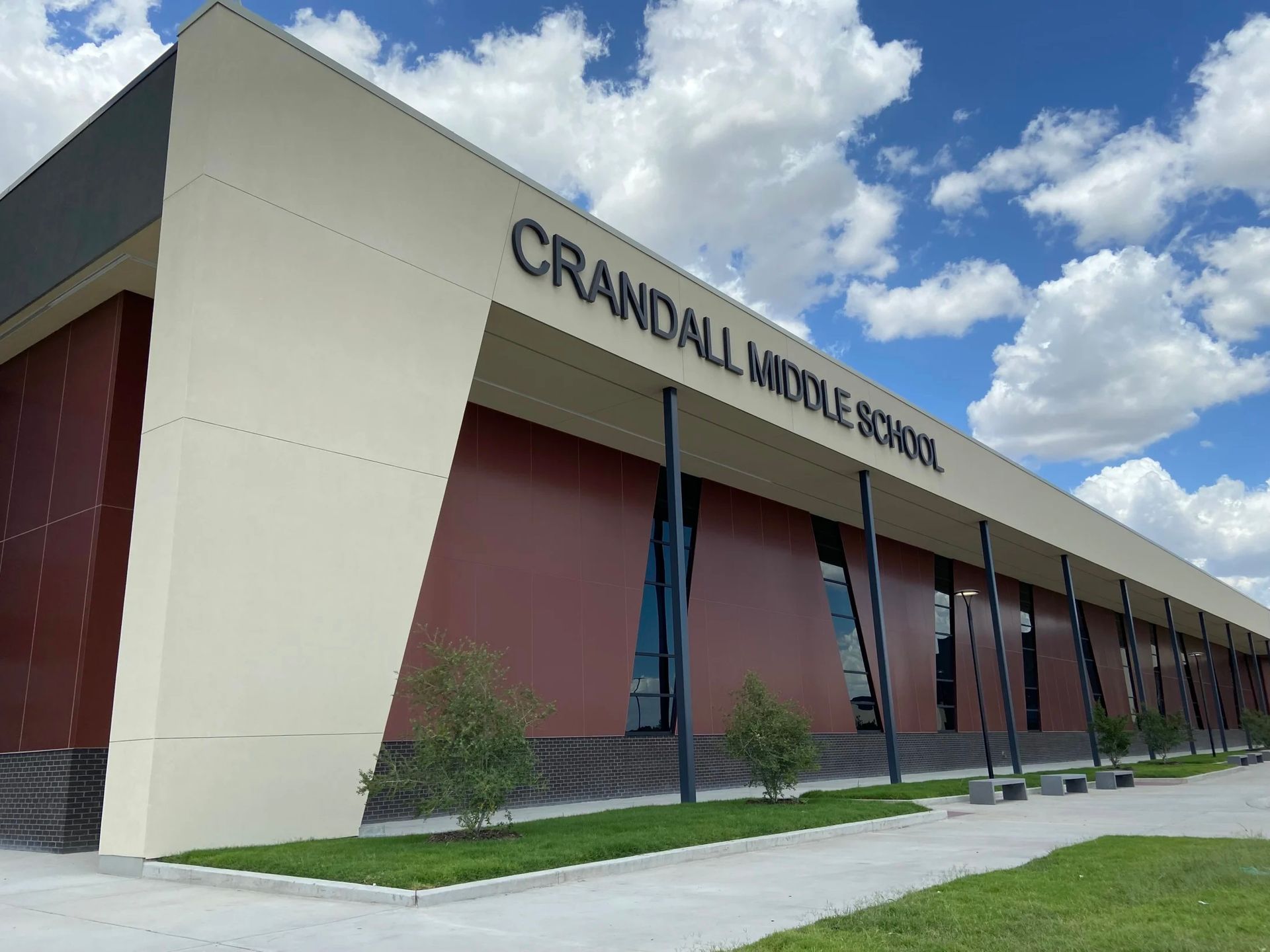 Crandell middle school is a large building with a lot of windows.