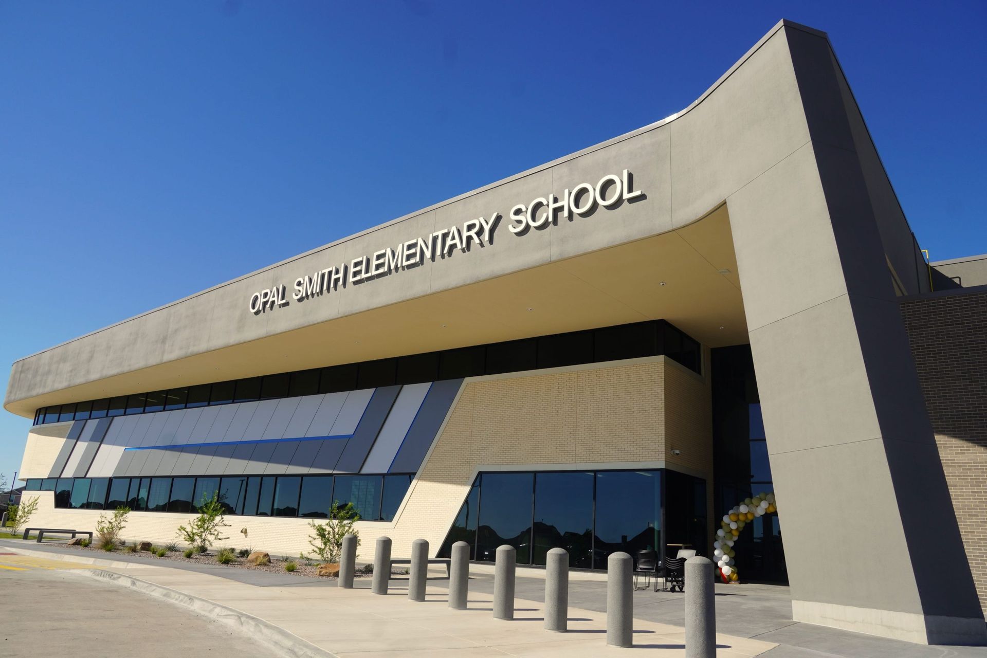 A large elementary school building with a blue sky in the background