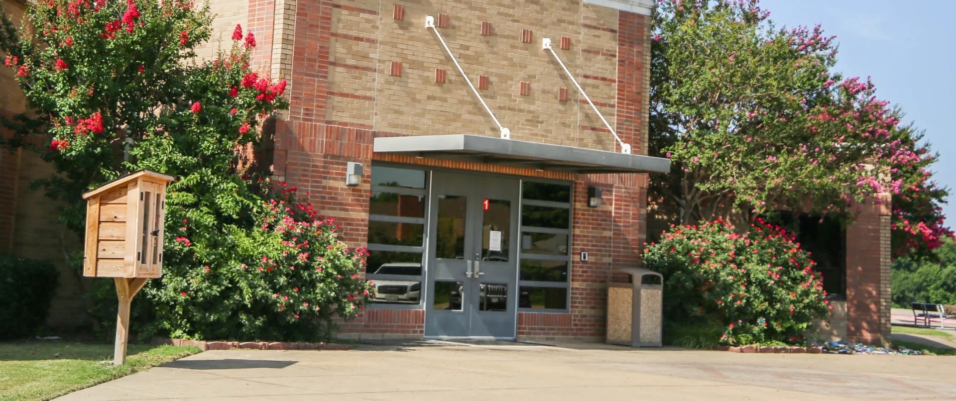 A large brick building with a mailbox in front of it.
