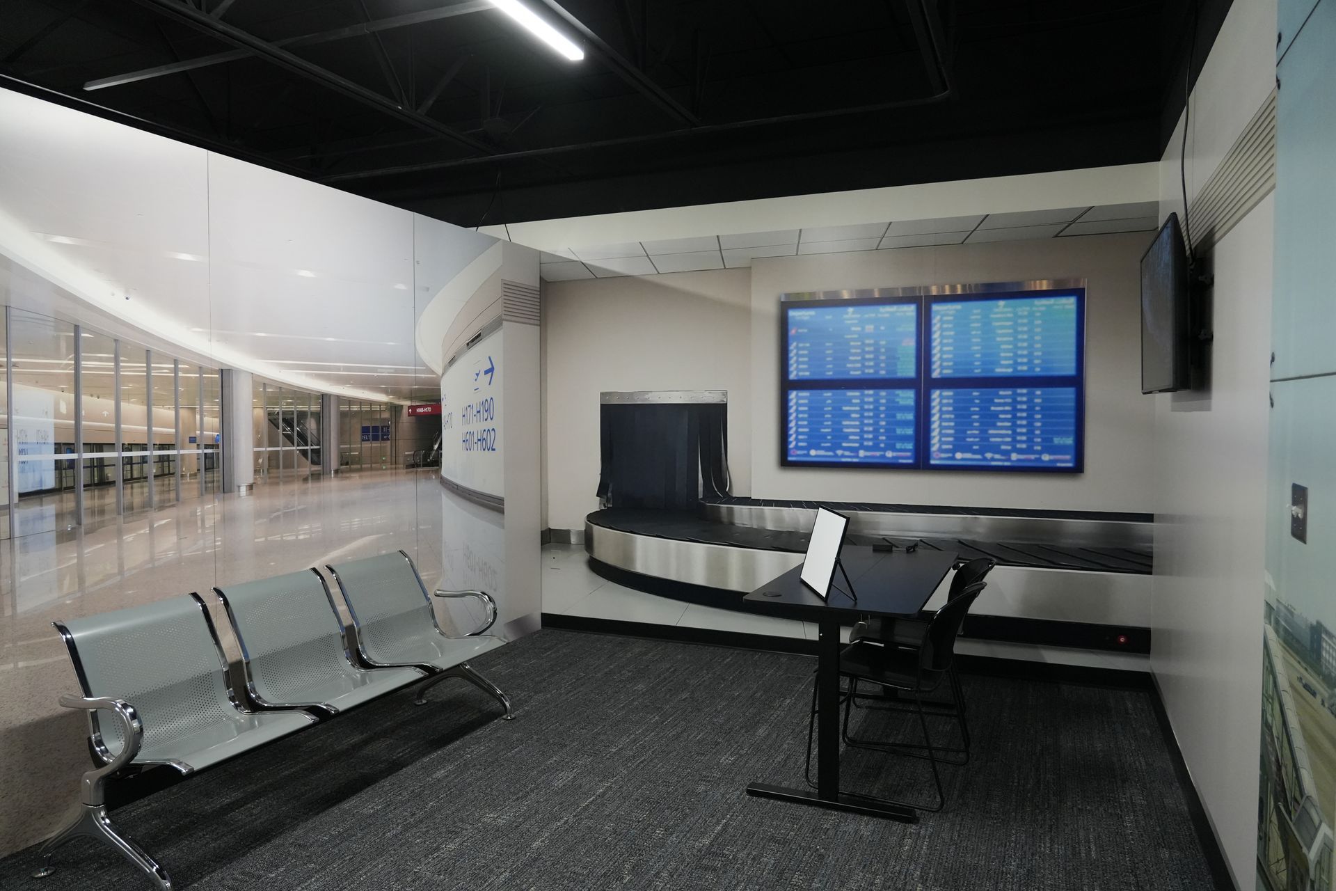 An airport waiting area with a table and chairs