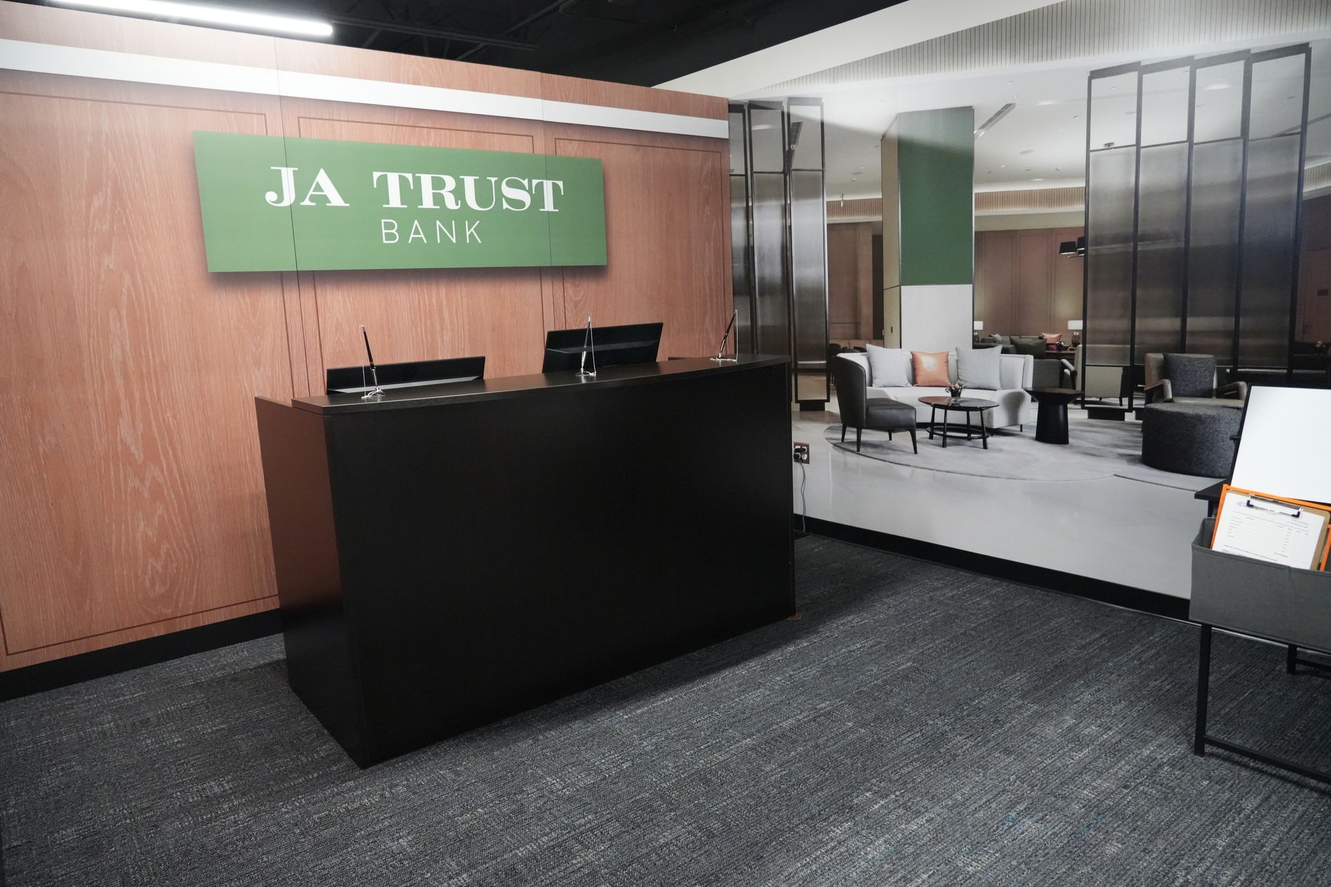 A ja trust bank lobby with a green sign on the wall