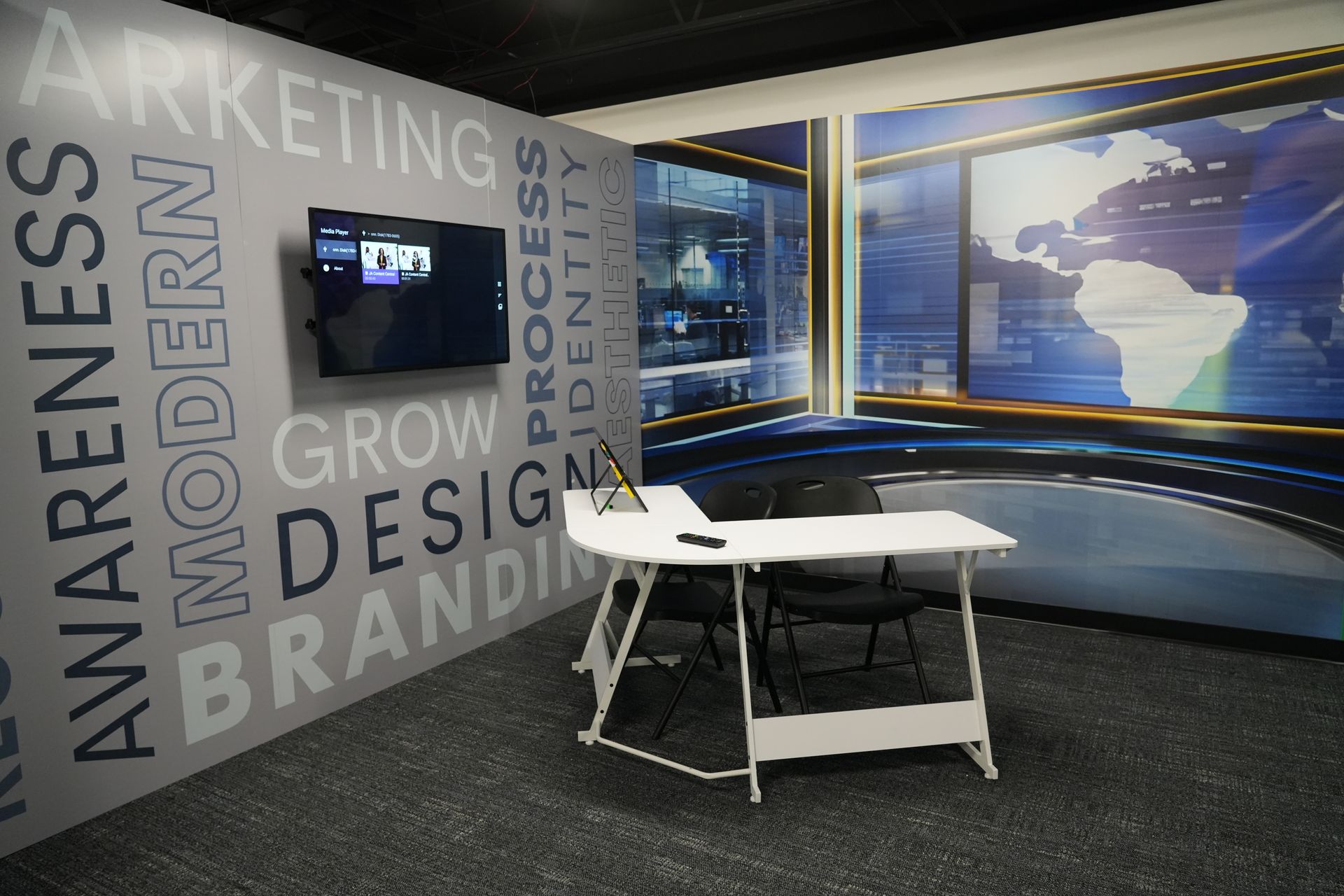A room with a table and chairs and a wall that says awareness on it