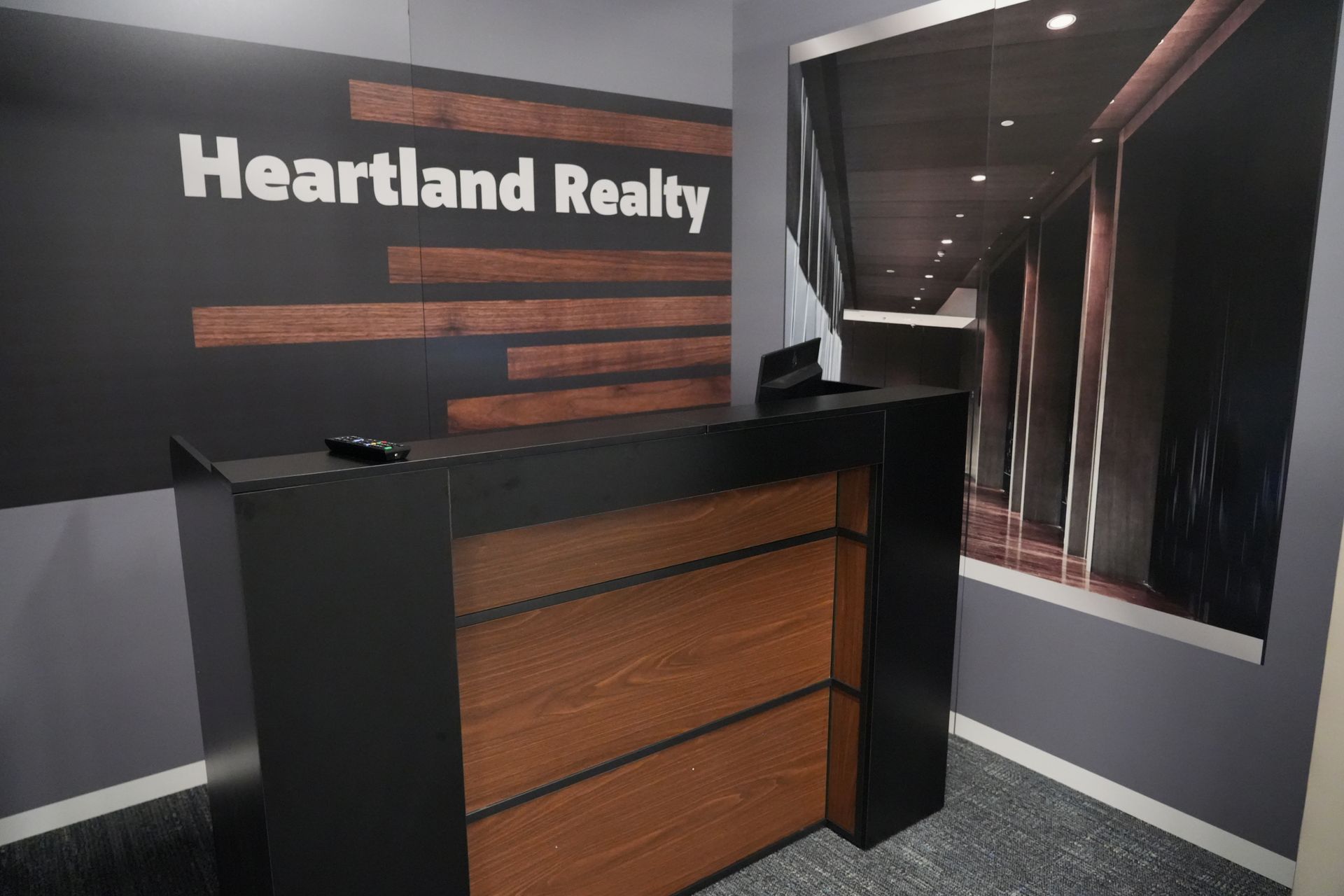 A heartland realty office with a wooden desk