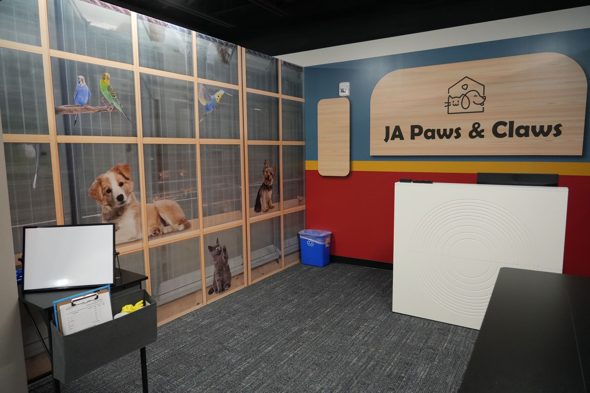 A dog is sitting in a cage in a room with a sign that says paws and claws.